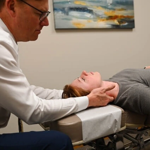 Dr. Steven Kraft performing a neck adjustment on a patient